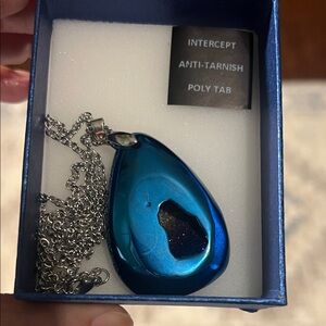 Blue stone pendant on silver chain
